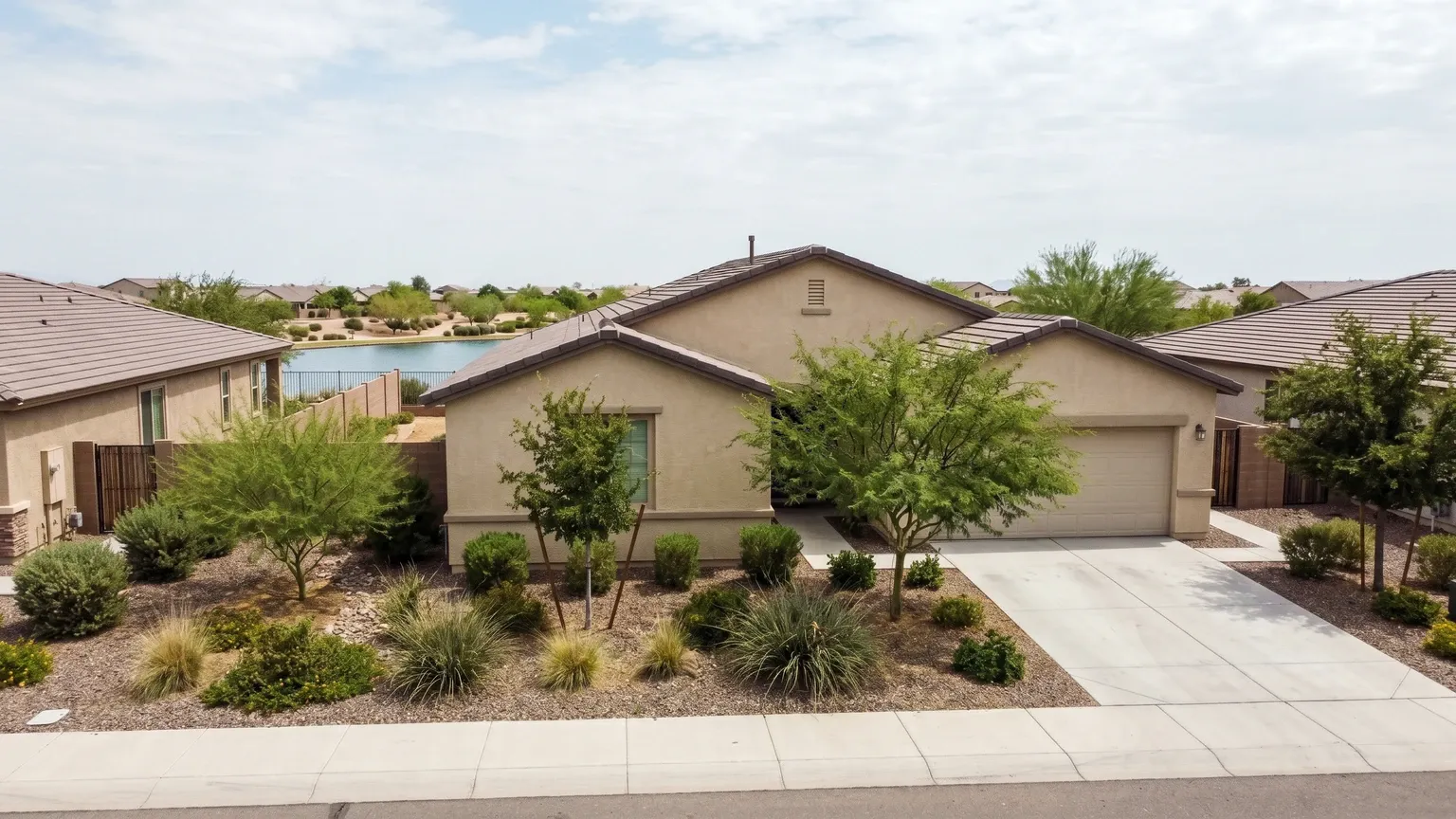 A brand-new stucco home under construction in a large Goodyear Arizona subdivision, where construction moisture and first-summer AC load are common mold sources.