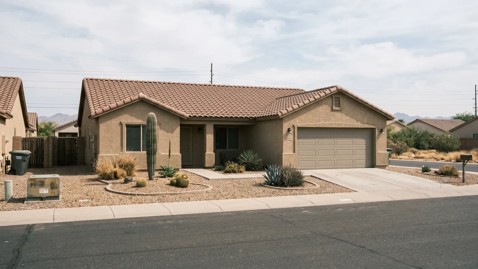 A closed-up seasonal Surprise Arizona home with shuttered windows and desert landscaping, representing the snowbird vacancy pattern that hides summer mold damage.